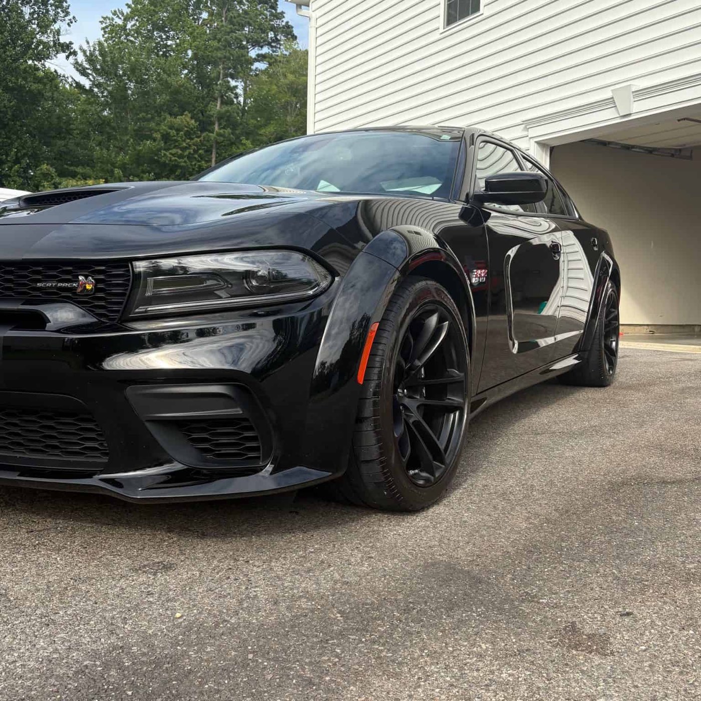 Freshly detailed black Dodge Charger in a Calvert County driveway